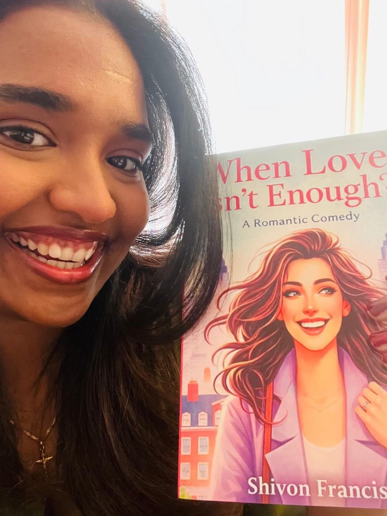 Shivon is holding her book, When Love Isn’t Enough.