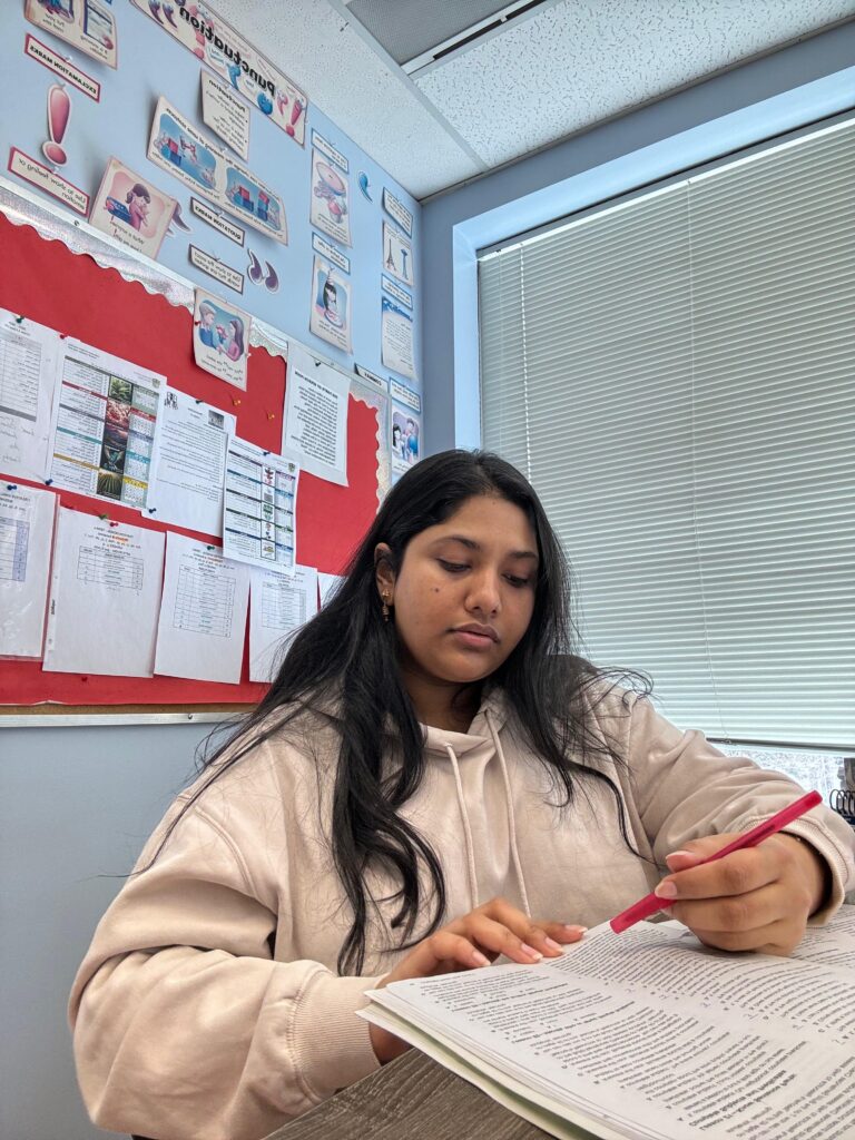 Amatullah reading in the classroom.