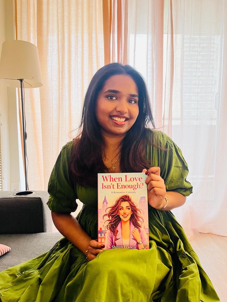 Shivon Francis is wearing a green dress and holding her book, When Love Isn’t Enough.