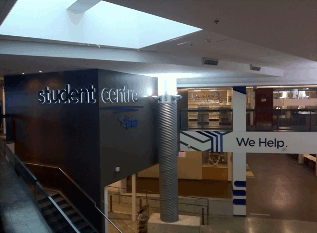 Student centre at Humber with a motto on a wall which says, "We Help"