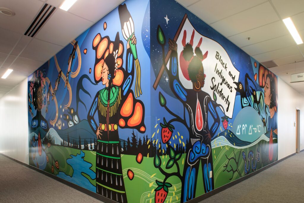 A humber mural. Some text reads Black and Indigenous solidarity.