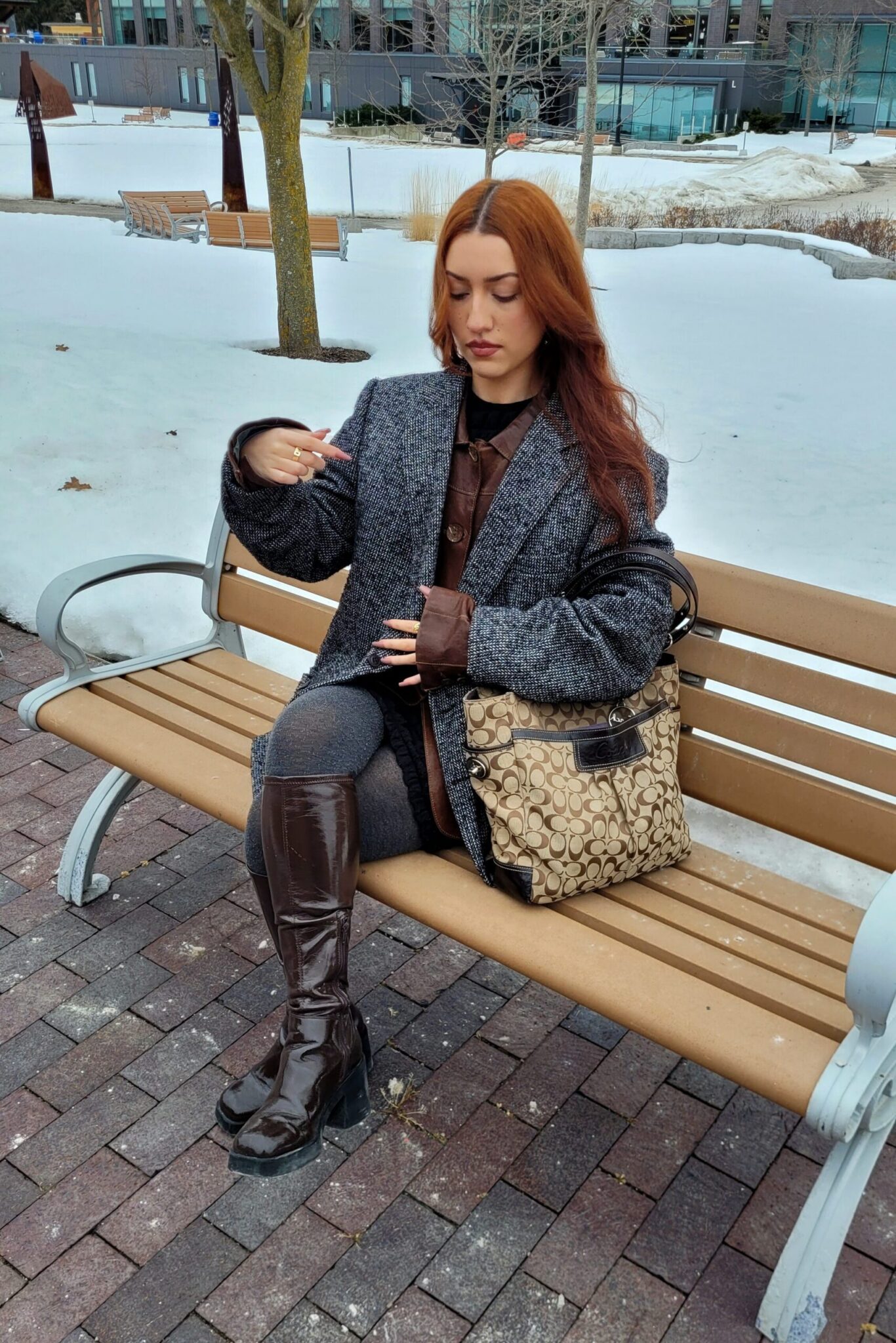 Student sitting on a bench with thrifted outfit