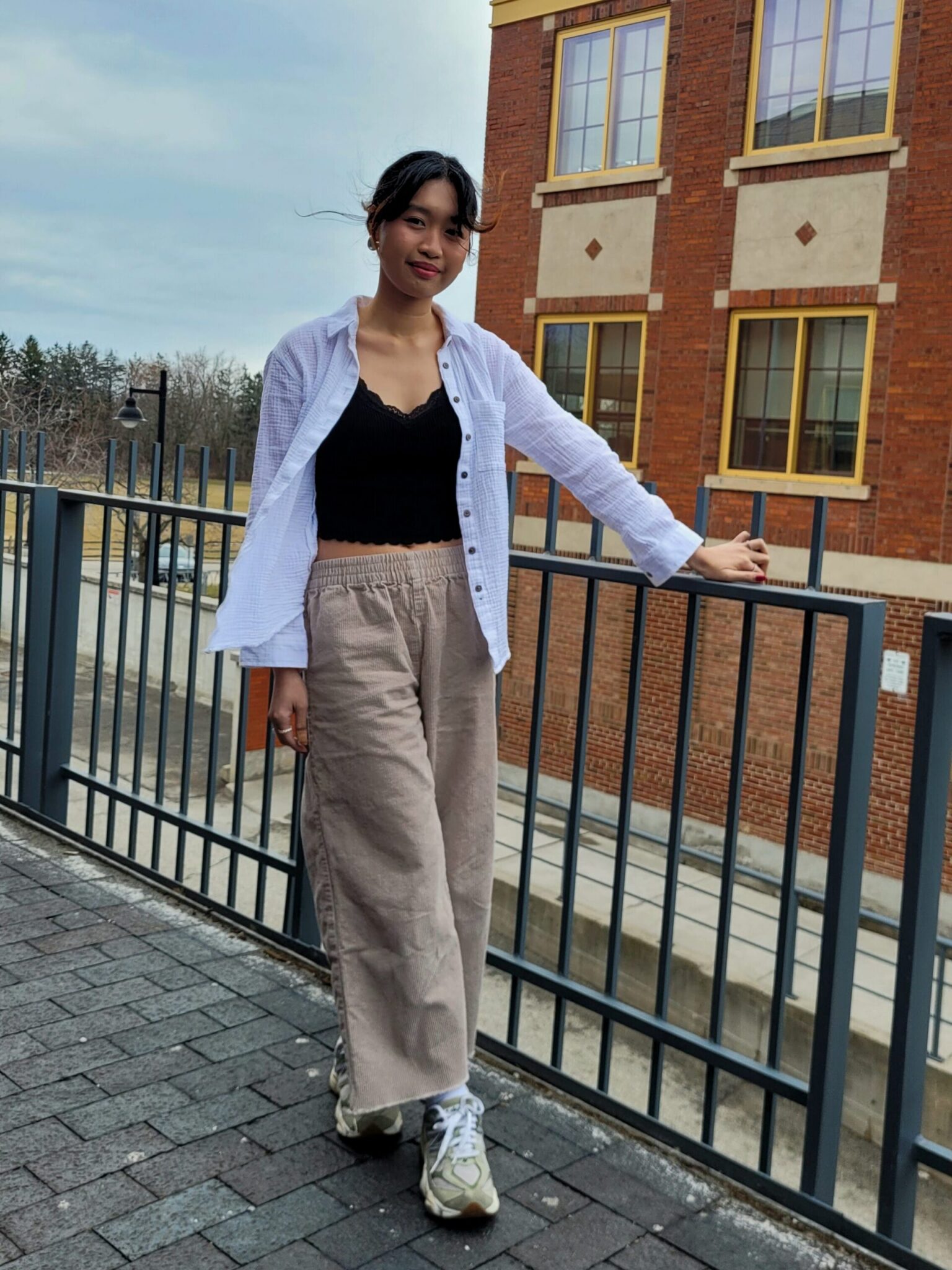 Girl in casual clothes inspired by K-pop fashion and Y2K style.