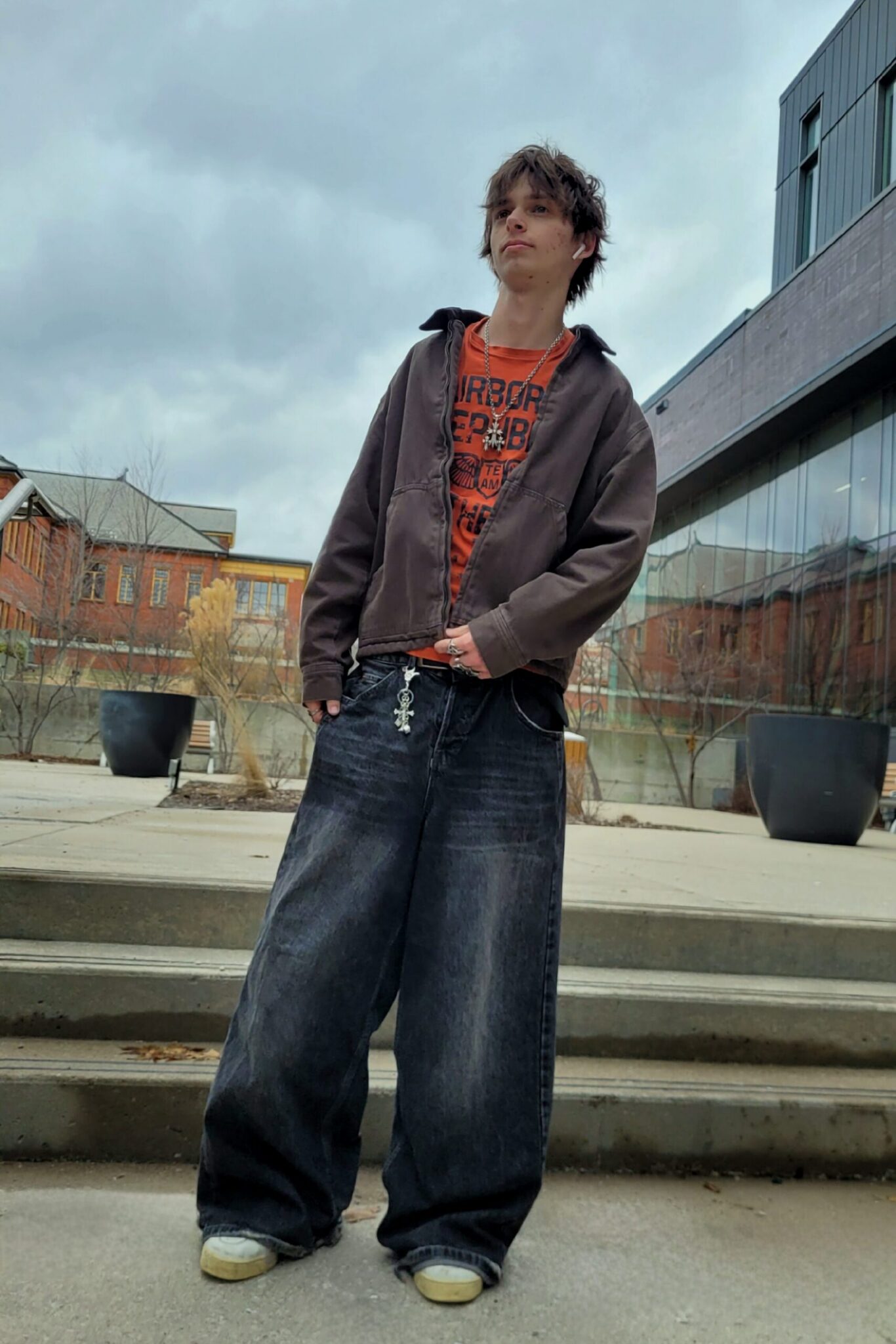 Male streetwear with baggy clothes and metal accessories.
