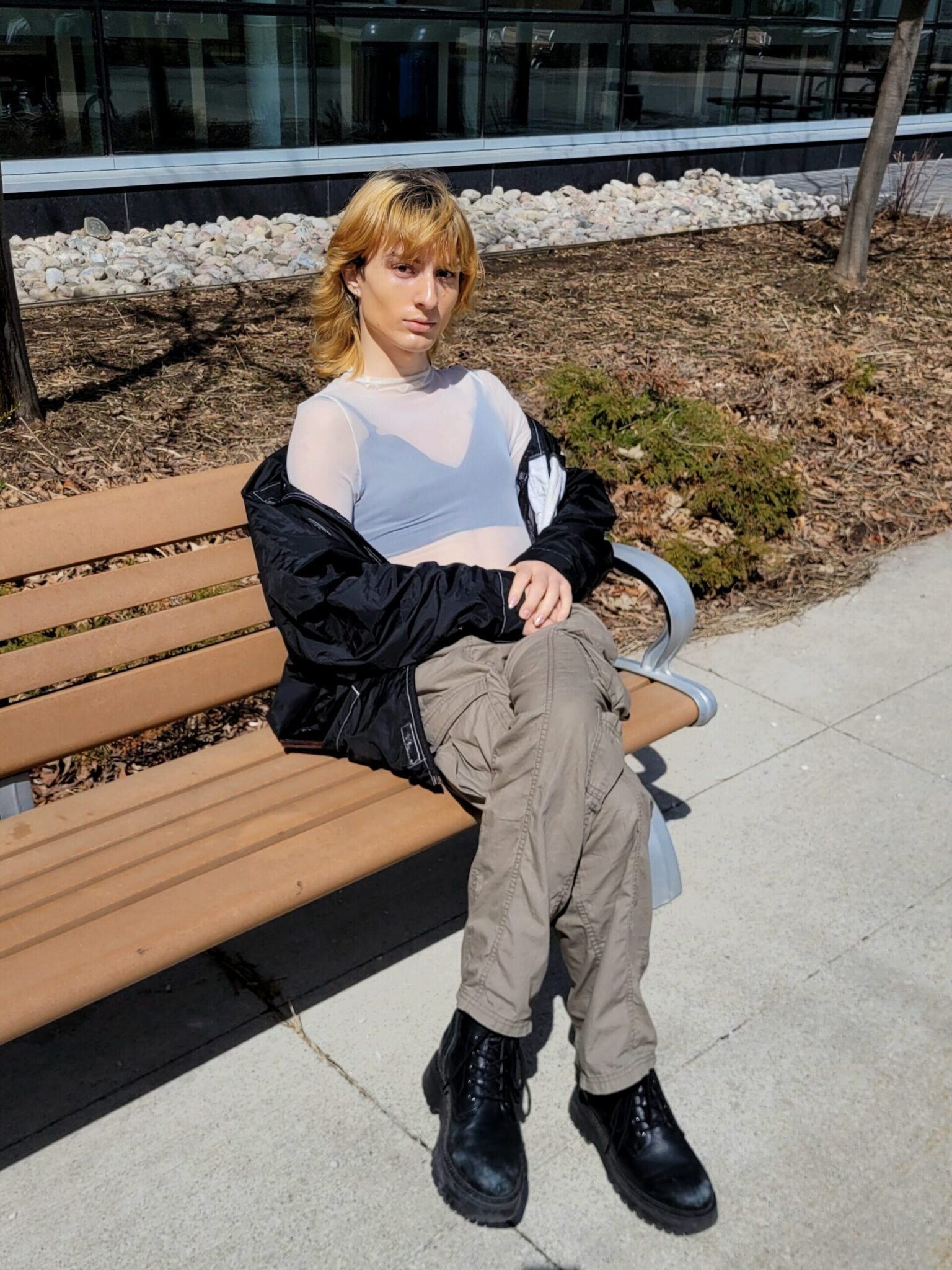Student portraying the femme fashion style while sitting outside Humber Polytechnic North campus 