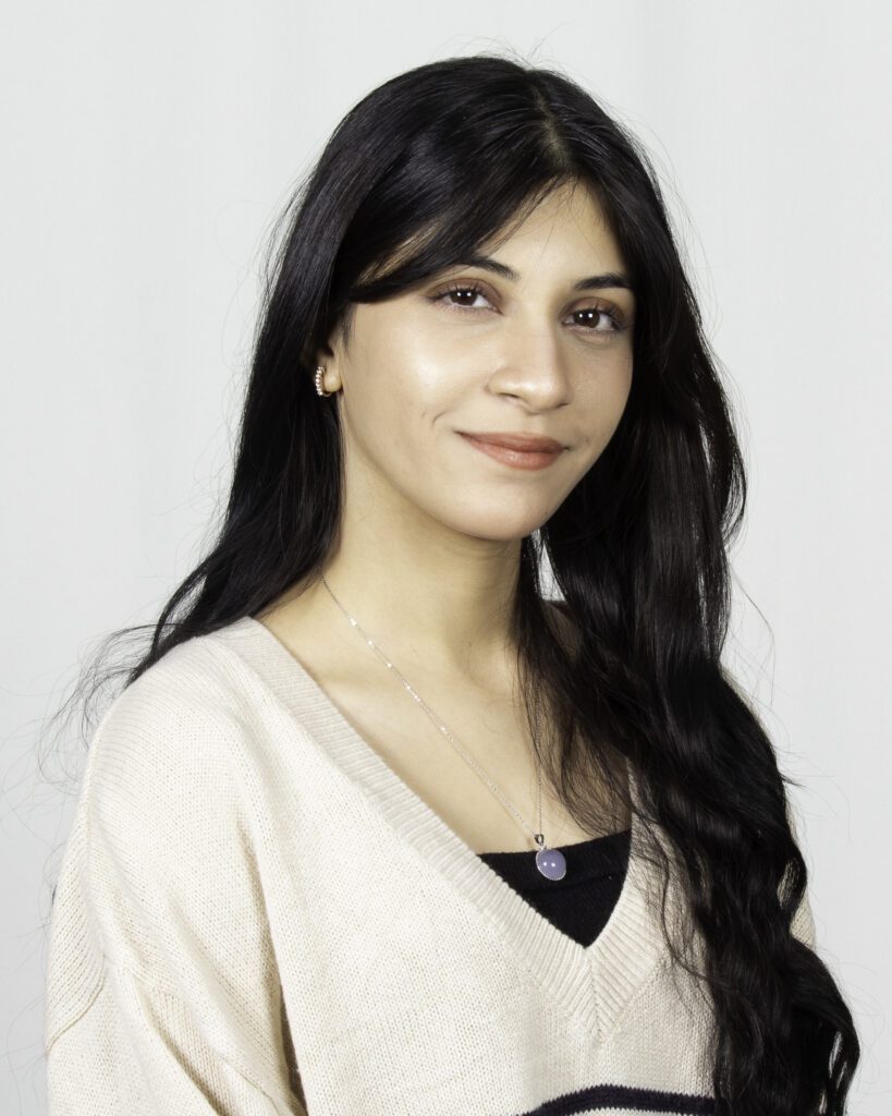 A headshot of a girl wearing a whote shirt.