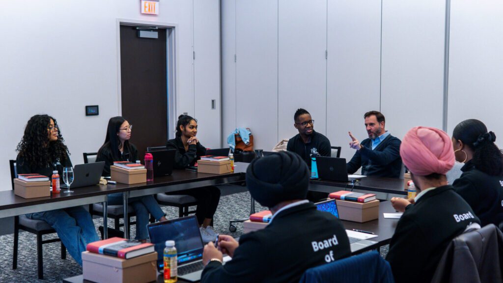 A large group of people are attending a meeting.