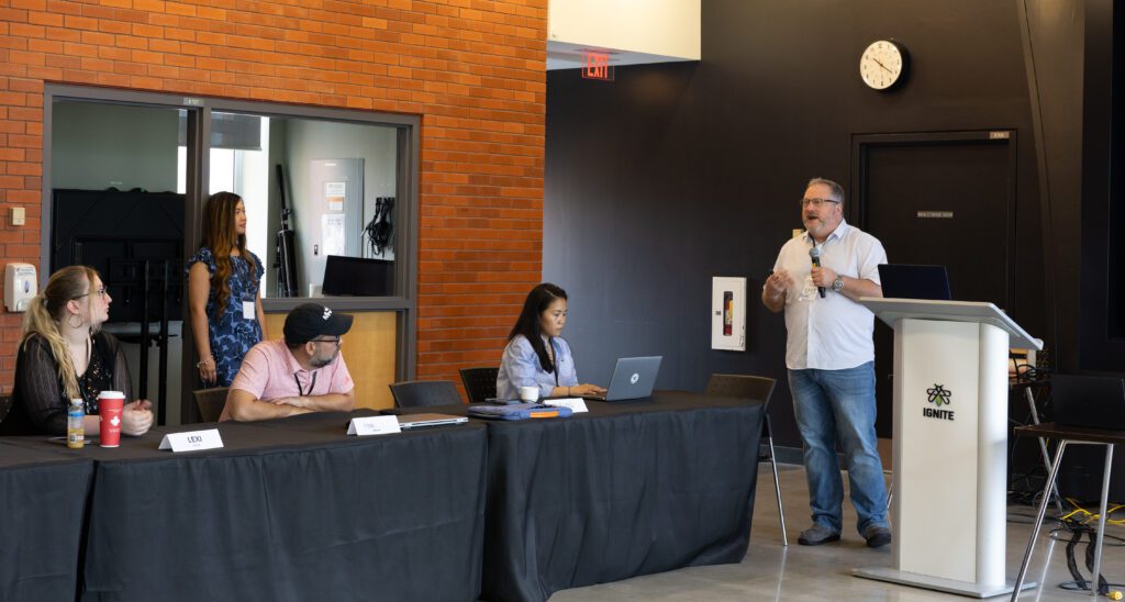 A man is speaking at a conference.