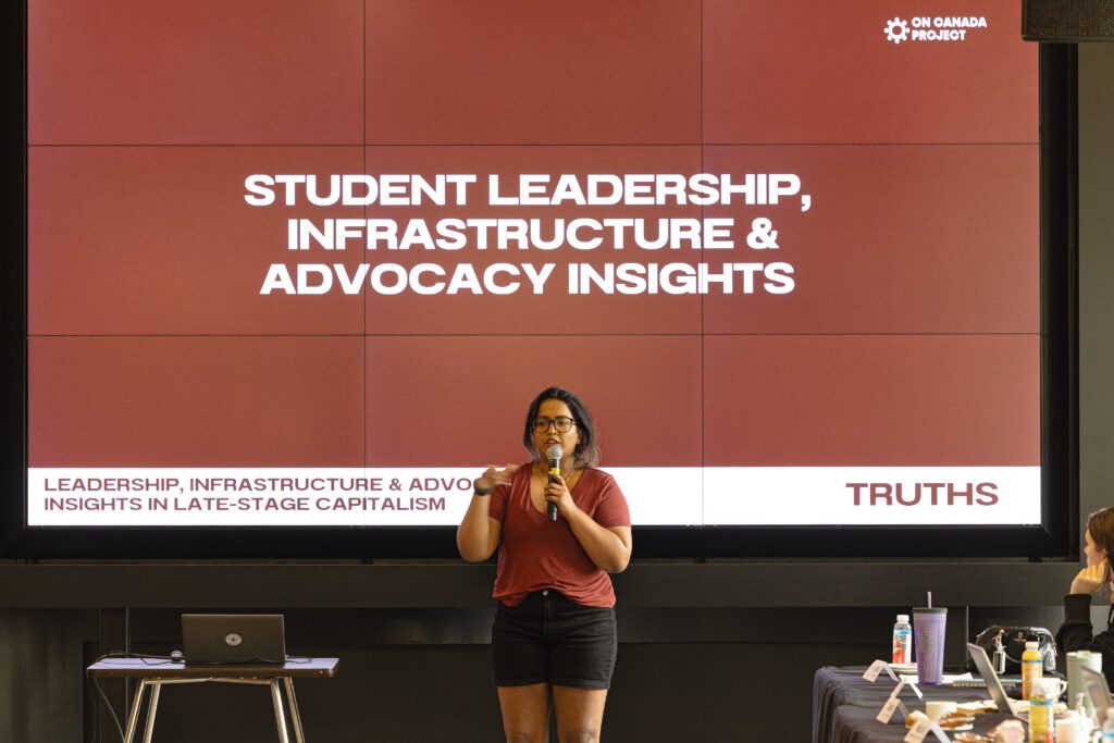 A woman is speaking at a conference.