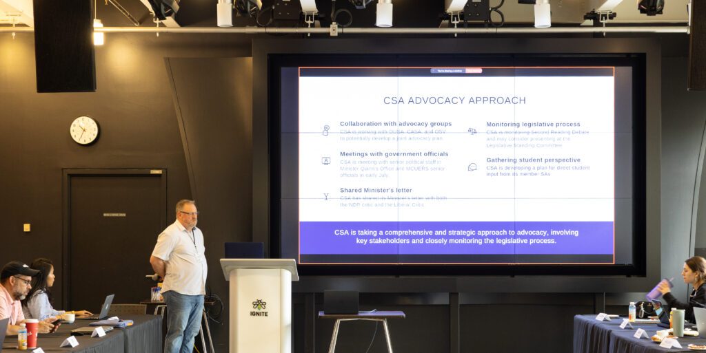 A man is giving a presentation at a conference.