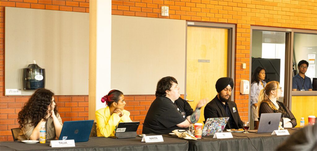 A group of people are sitting in a conference.