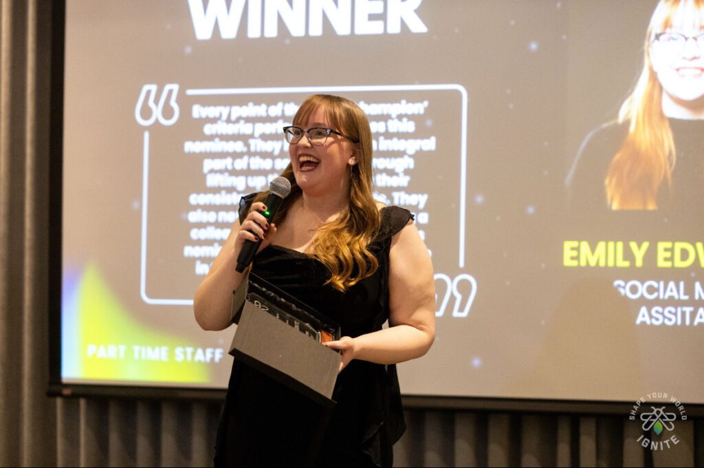 Student Advocate Emily Edwards speaking to a crowd at the IGNITE awards.