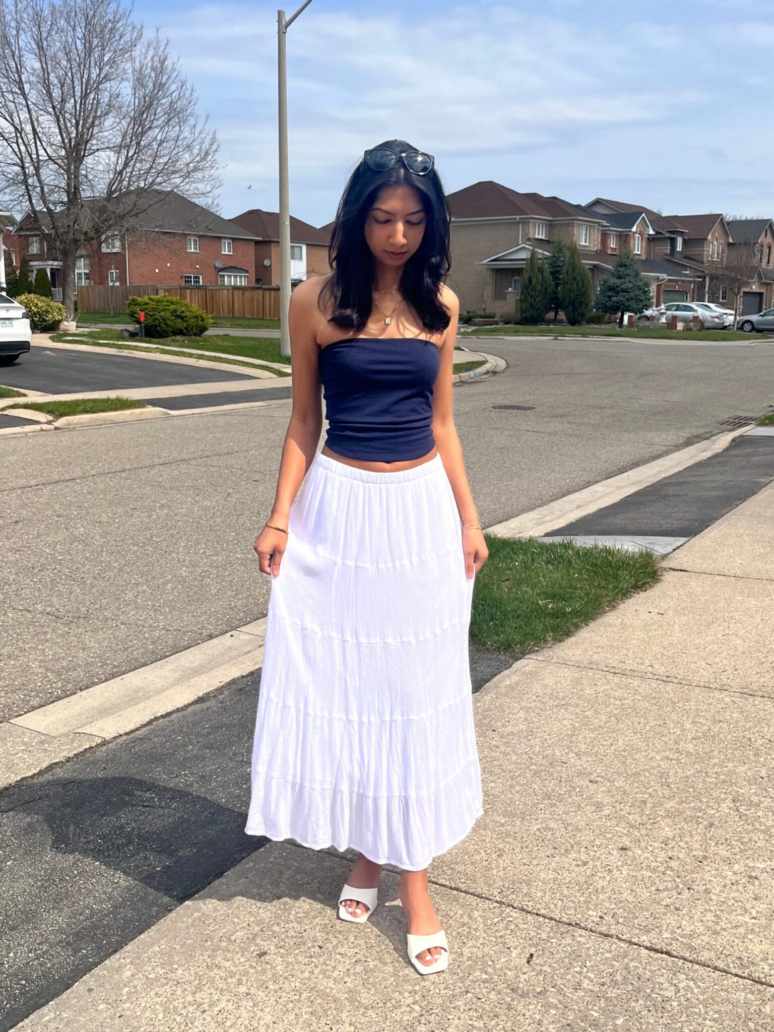Summer womenswear style featuring student using a long skirt, tube top and sandals
