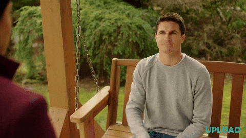 a man sitting on a swing, moving his arm in a line where five stars follow the movement. 
