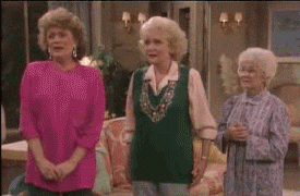 Four old ladies doing a group hug