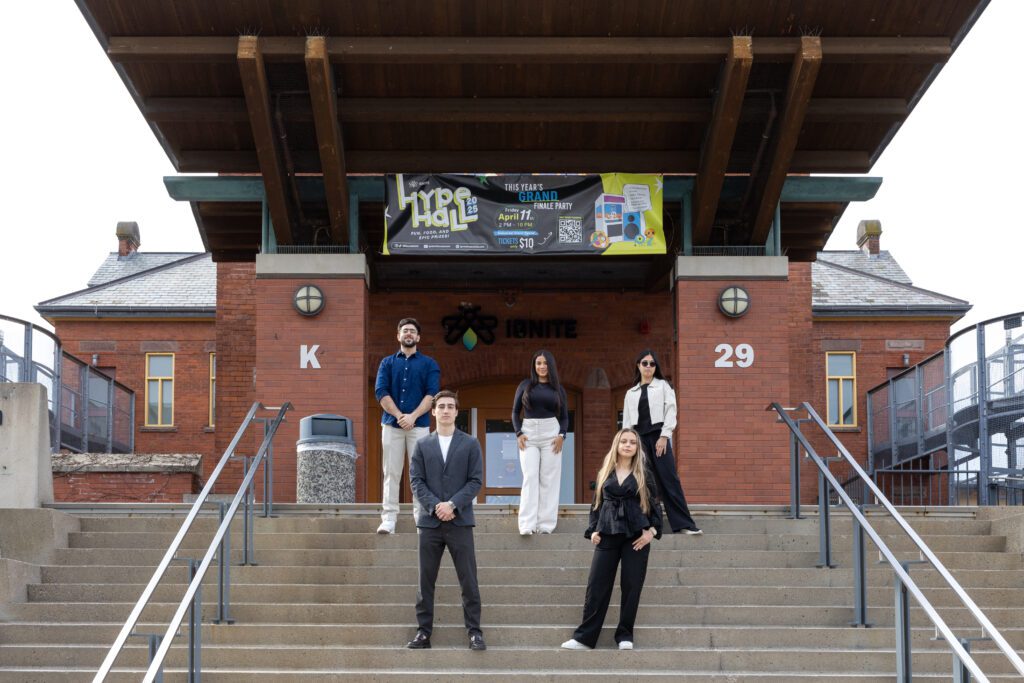 IGNITE Board of Directors standing on the IGNITE building staircase at the Lakeshore campus.