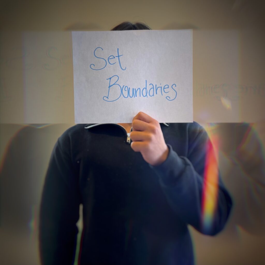 A guy holding a paper saying "Set Boundaries".