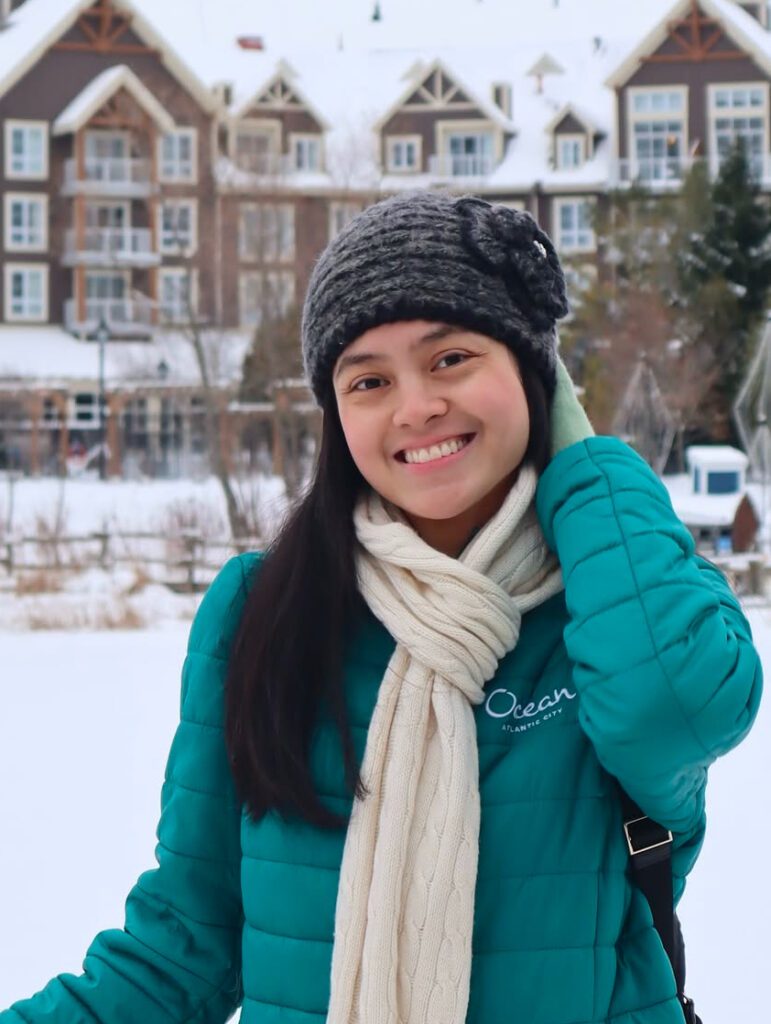 A picture of a girl standing outside in a snow. internships