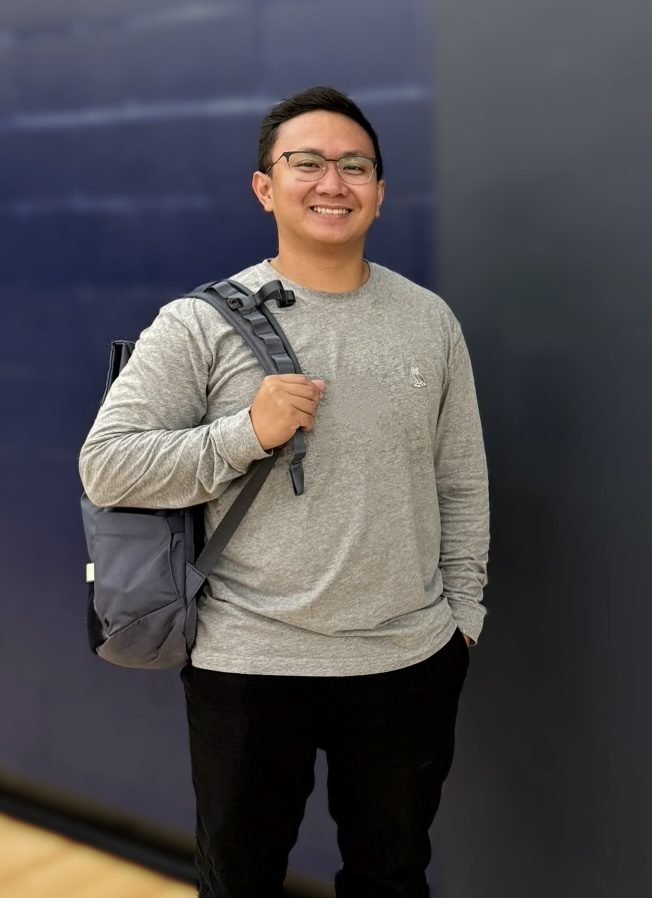 A picture of a guy standing with is backpack. internships