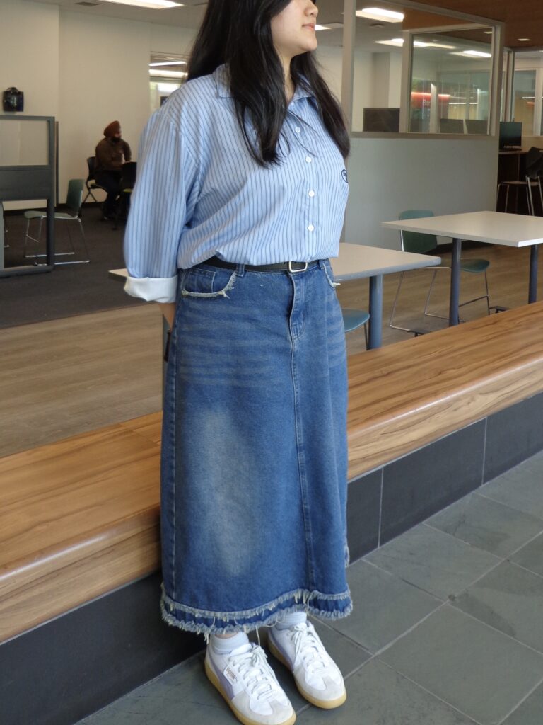 A woman is standing indoors.