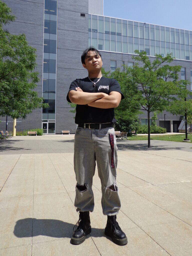A man is posing outdoors.