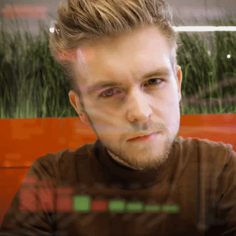 A man looking at the screen with a magnifying glass.