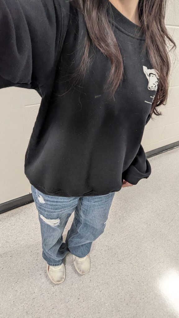A girl taking a selfie of her outfit. street