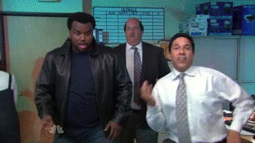 three people dancing in an office party