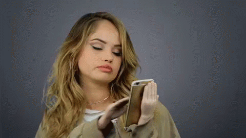 A girl scrolls through her phone.