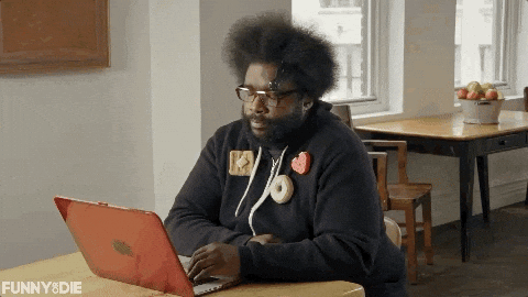 A man is closing his laptop.