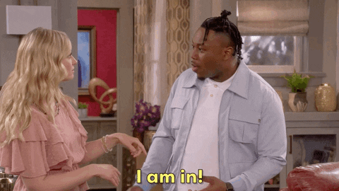 A man is saying the words, "I am in!" to a woman.