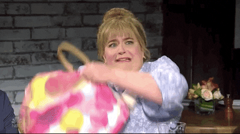 A woman is putting a bag over her head. 