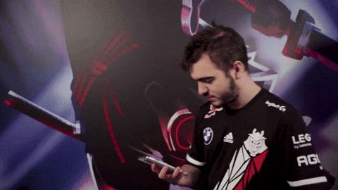 A man is scrolling on his phone, then throwing it aside.