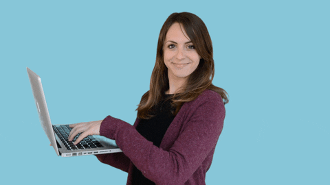 A woman is typing on her laptop.