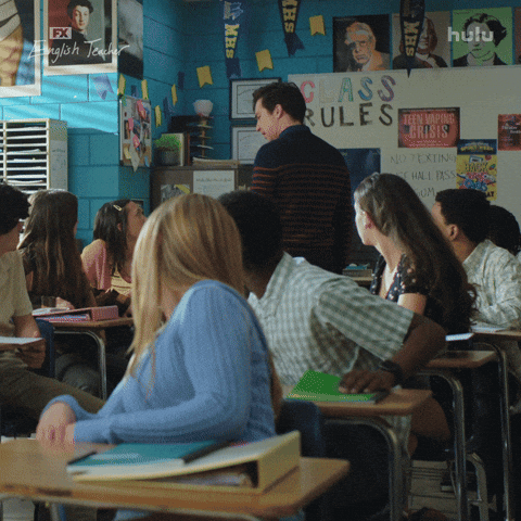 A teacher is saying to the students, "Class dismissed"