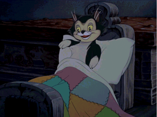 A cartoon cat is snuggling into bed, ready to sleep.