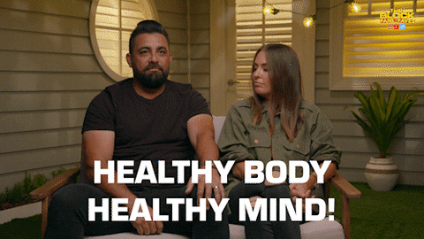 A man is saying "HEALTHY BODY HEALTHY MIND" to the woman sitting next to him.