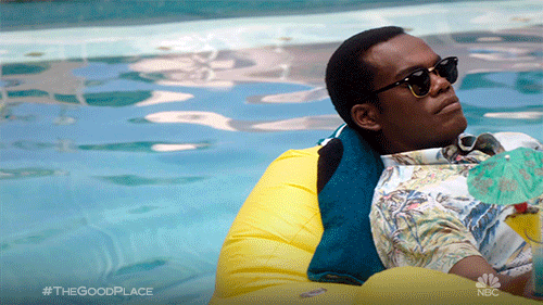 A man is lying on an inflatable, floating on water.