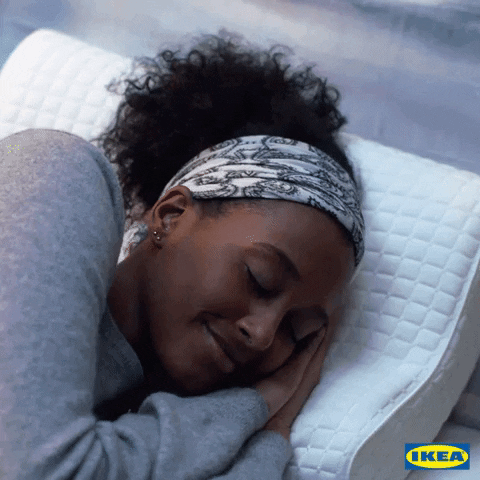 A woman is taking a cozy nap.