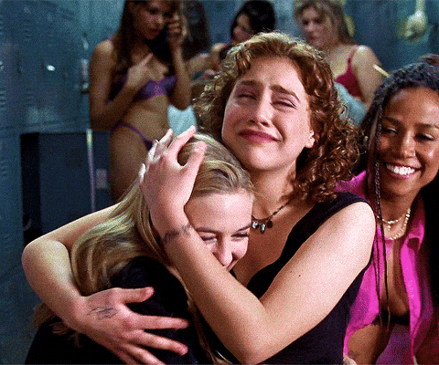 A group of three girls hugging each other lovingly.