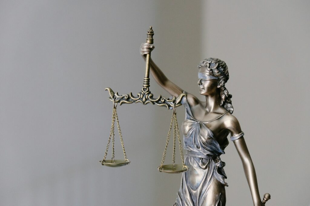 Statue of law with a woman in a dress holding a scale.
