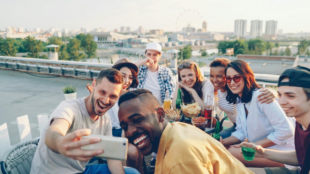 friends taking a selfie on a rooftop party