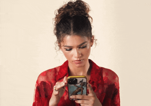 A girl is scrolling through her phone.