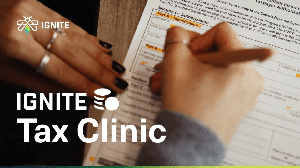 A person fills out a tax form with a pen. The words IGNITE Tax Clinic and the IGNITE logo are visible on the left side of the image.
