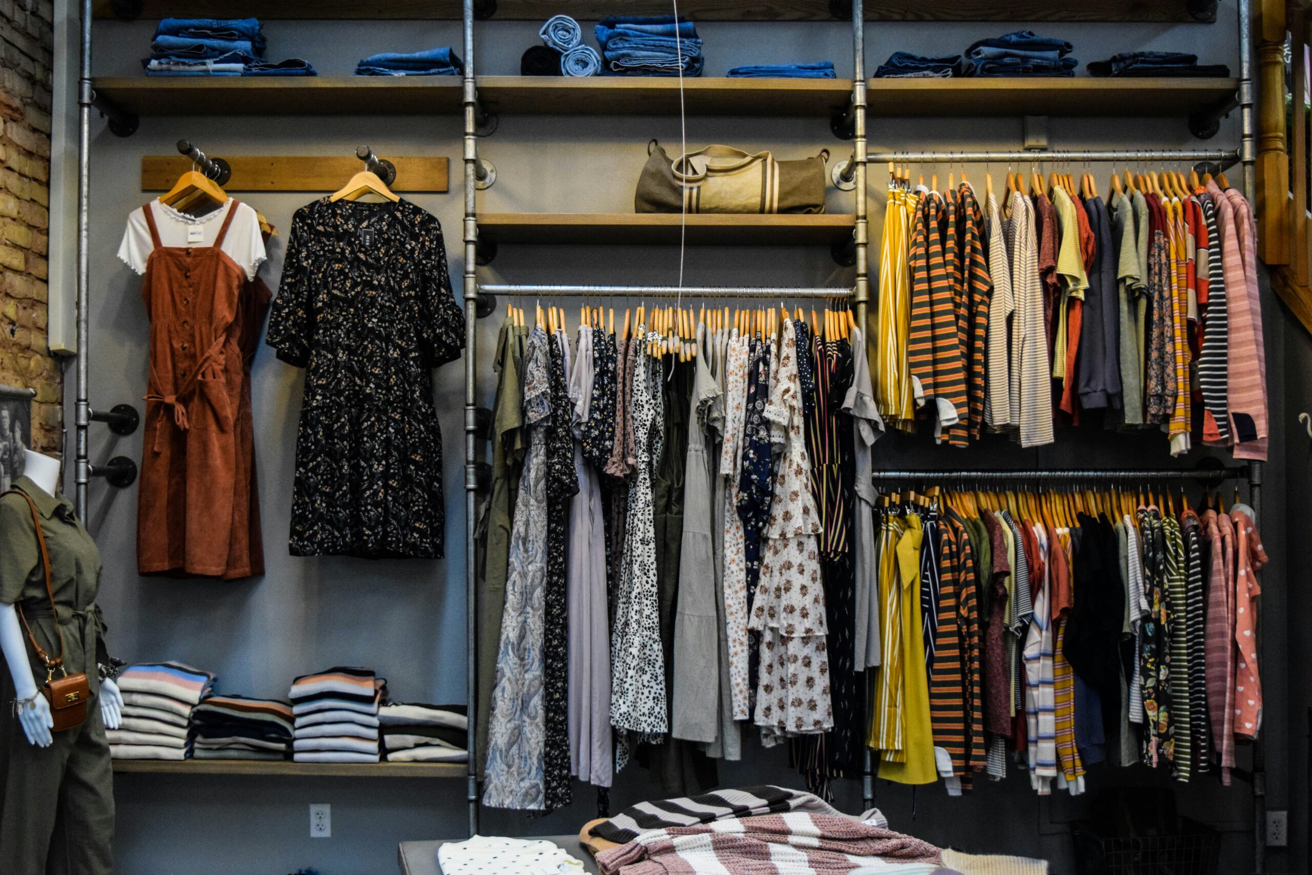 A front view photo of a clothing storing with various clothing stocked