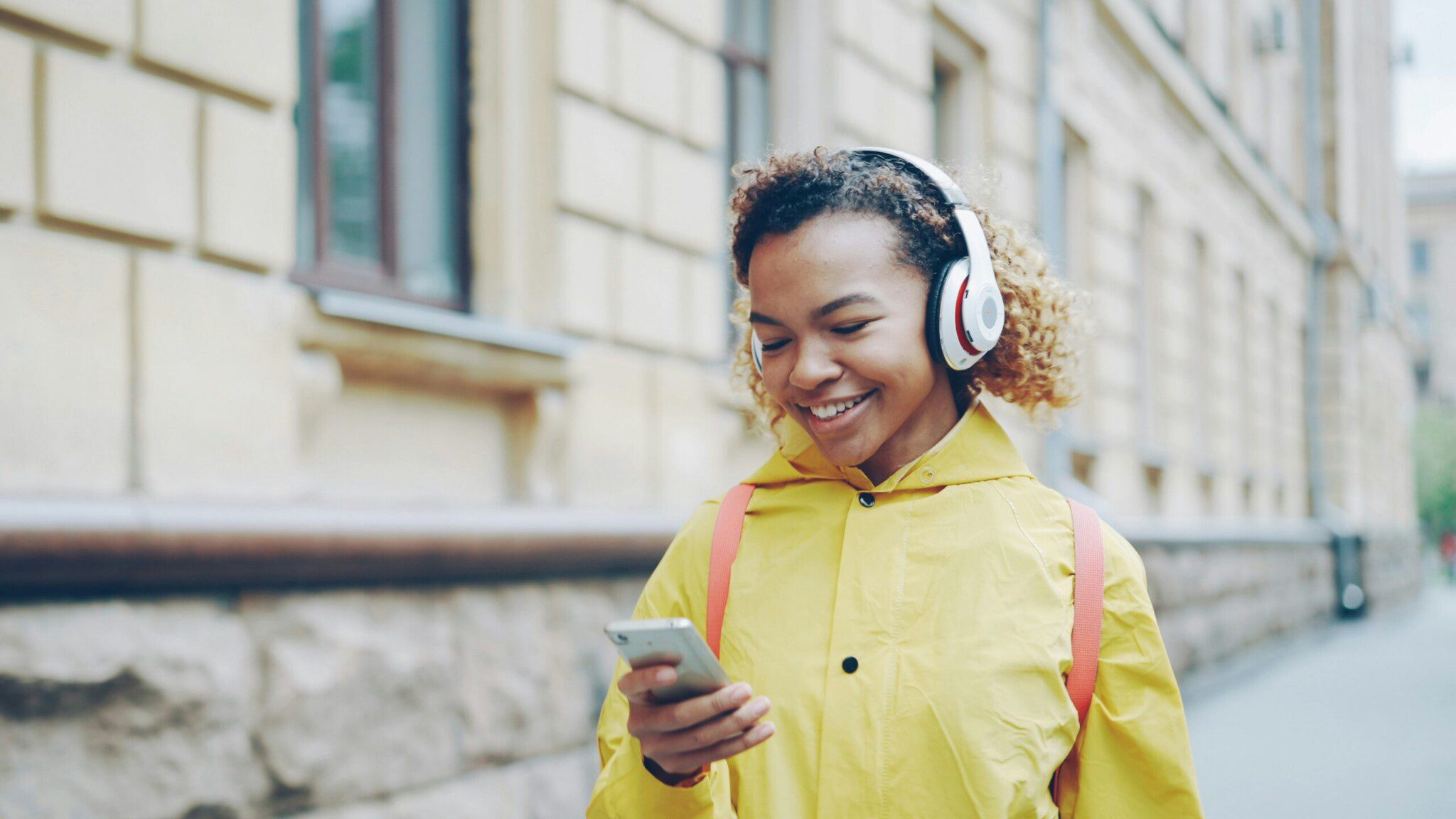 a woman using her phone smiling