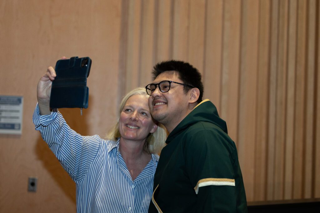 Catherine McKenna taking a selfie with a student