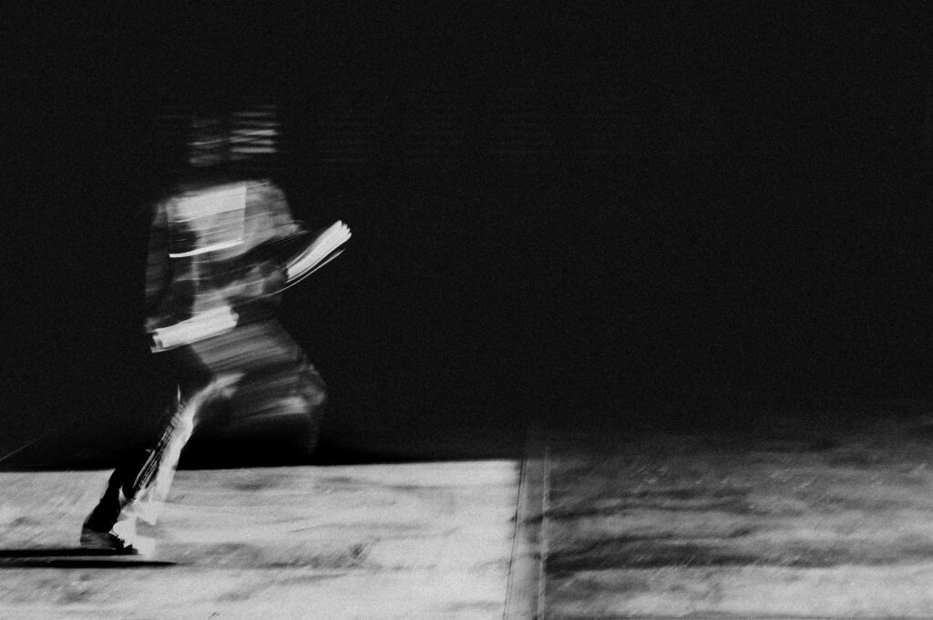A blurry b&W image of a person running