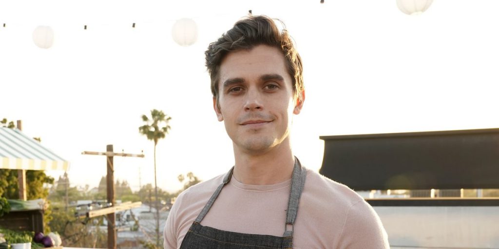 Antoni Porowski wearing an apron.