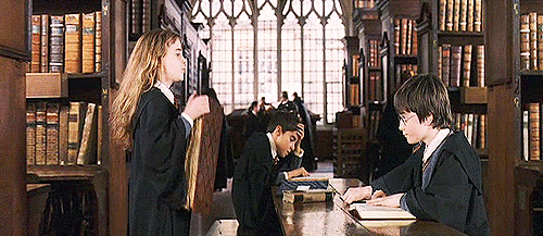A girl slamming a book onto a table